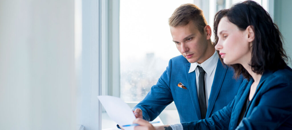a man in a suit looking at a piece of paper